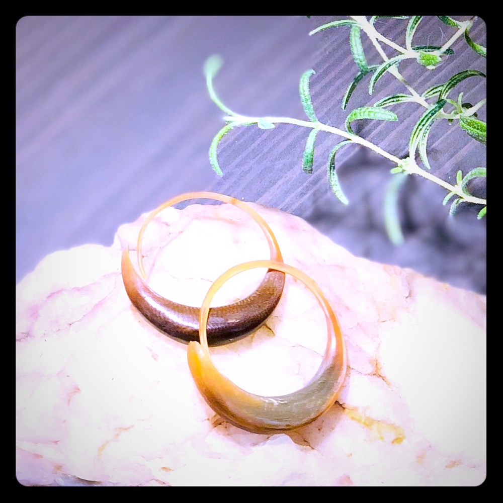 Hand carved horn hoop earrings.